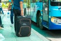 Luggage of a traveller at bus stop with the bus on background Royalty Free Stock Photo