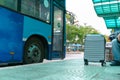 Luggage of a traveller at bus stop with the bus on background Royalty Free Stock Photo