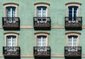 Close-up view of house front with French doors and small balconies