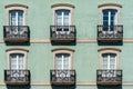 Close-up view of house front with French doors and small balconies