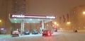 Lukoil gas station in the winter evening in a snowfall