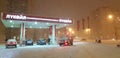 Lukoil gas station in the winter evening in a snowfall