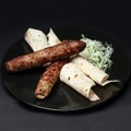 Lula kebab with greens on a black plate on a black background Royalty Free Stock Photo