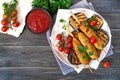 Lula kebab with grilled eggplant on pita bread. Dietary chicken kebabs on a skewer with vegetables Royalty Free Stock Photo