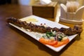 Lula kebab meat dish with vegetables served in restaurant on wooden table. Barbecue Royalty Free Stock Photo