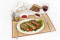 Lula kebab with tomatoes and cucumbers. Serve with black or white bread and a glass of red wine.