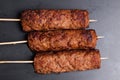 Lula kebab on wooden skewers dark baking