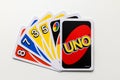 A hand of Uno card game cards with one card reversed side up.