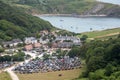 Looking down to Lulworth Cove with large number of cars in carpark