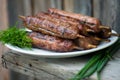 Lulya kebab from meat on a white plate and wooden board with dill and green onions. Royalty Free Stock Photo