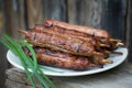 Lulya kebab from meat on a white plate and wooden board with green onions. Royalty Free Stock Photo