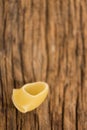 Lumache rigate pasta on wooden surface Royalty Free Stock Photo