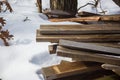 Lumber in frozen woods surrounded by snow
