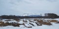 A lumbering yard under a snowy mountian