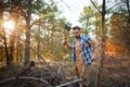 Lumberjack with an ax chop branches.