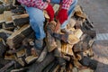 Lumberjack with big ax sits on pile of firewood