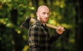 Lumberjack carry ax. Bald woodsman. Harvest firewood. Hike vacation. Hike in forest. Forest care. Determination of human Royalty Free Stock Photo