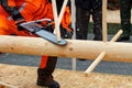A lumberjack with a chainsaw at a competition to demonstrate professional use of the tool Royalty Free Stock Photo