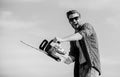 Lumberjack with chainsaw in his hands. Masculinity concept. Sharp blade. Dangerous job. Feeling manly. Powerful chainsaw Royalty Free Stock Photo