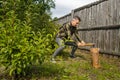 Lumberjack chopping wood. Young man chopping woods with an axe Royalty Free Stock Photo