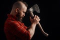 Lumberjack. Confident bearded man attached to forehead axe