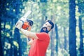 Lumberjack holding the chainsaw. Deforestation is a major cause of land degradation and destabilization of natural Royalty Free Stock Photo