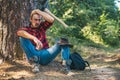 Lumberjack man sitting in the forest. Illegal logging continues today. Lumberjack worker standing in the forest with axe