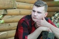 Lumberjack wearing red checked shirt and blue jeans outdoor portrait