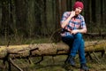 A lumberjack in the woods resting