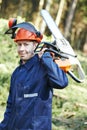 Lumberjack worker with chainsaw in the forest Royalty Free Stock Photo