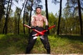 Lumberjack worker standing with two big crossed axes in the fore
