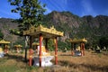 View on idyllic secluded valley with countless sitting buddha statues against Mountain face and blue sky