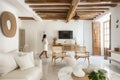 Lumination interior design photography of an apartment with white walls and wooden beams on the ceiling. The living room