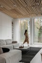 Lumination interior design photography of an apartment with white walls and wooden beams on the ceiling. The living room