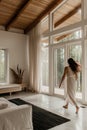 Lumination interior design photography of an apartment with white walls and wooden beams on the ceiling. The living room