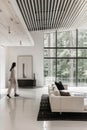 Lumination interior design photography of an apartment with white walls and wooden beams on the ceiling. The living room