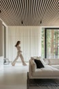 Lumination interior design photography of an apartment with white walls and wooden beams on the ceiling. The living room