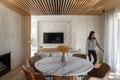 Lumination interior design photography of an apartment with white walls and wooden beams on the ceiling. The living room