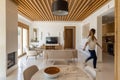 Lumination interior design photography of an apartment with white walls and wooden beams on the ceiling. The living room