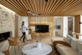 Lumination interior design photography of an apartment with white walls and wooden beams on the ceiling. The living room