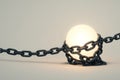 The luminous ball is tied with chains. Royalty Free Stock Photo