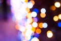 Luminous blurred and defocused colorful christmas lights on dark background with bokeh effect Royalty Free Stock Photo