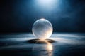 A luminous orb rests on a dark, reflective surface, illuminated by a dramatic spotlight, creating an enigmatic and mysterious Royalty Free Stock Photo