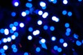 Unfocused blurred blue christmas shiny lights on dark background for wallpaper Royalty Free Stock Photo