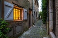 Luminous window in the evening at the old steets