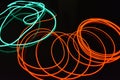Neon green and red thin wire. Luminous wires, decoration and illumination of the surface. Electroluminescent wire, lighting object