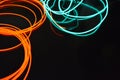 Neon green and red thin wire. Luminous wires, decoration and illumination of the surface. Electroluminescent wire, lighting object