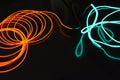 Neon green and red thin wire. Luminous wires, decoration and illumination of the surface. Electroluminescent wire, lighting object