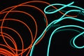 Neon green and red thin wire. Luminous wires, decoration and illumination of the surface. Electroluminescent wire, lighting object