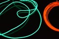 Neon green and red thin wire. Luminous wires, decoration and illumination of the surface. Electroluminescent wire, lighting object